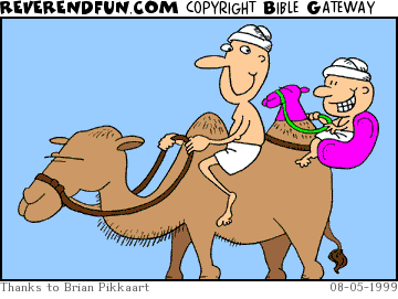 DESCRIPTION: Guy riding camel, son on back with fake camel riding gear CAPTION: 
