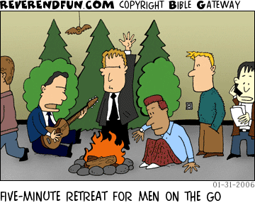 DESCRIPTION: A few guys sitting around a fake campfire and fake trees.  Others waiting in line to take their turns. CAPTION: FIVE-MINUTE RETREAT FOR MEN ON THE GO